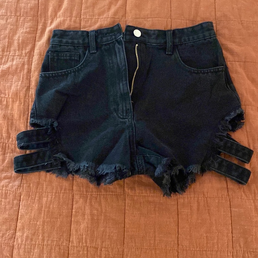 Black jean shorts with straps on thigh